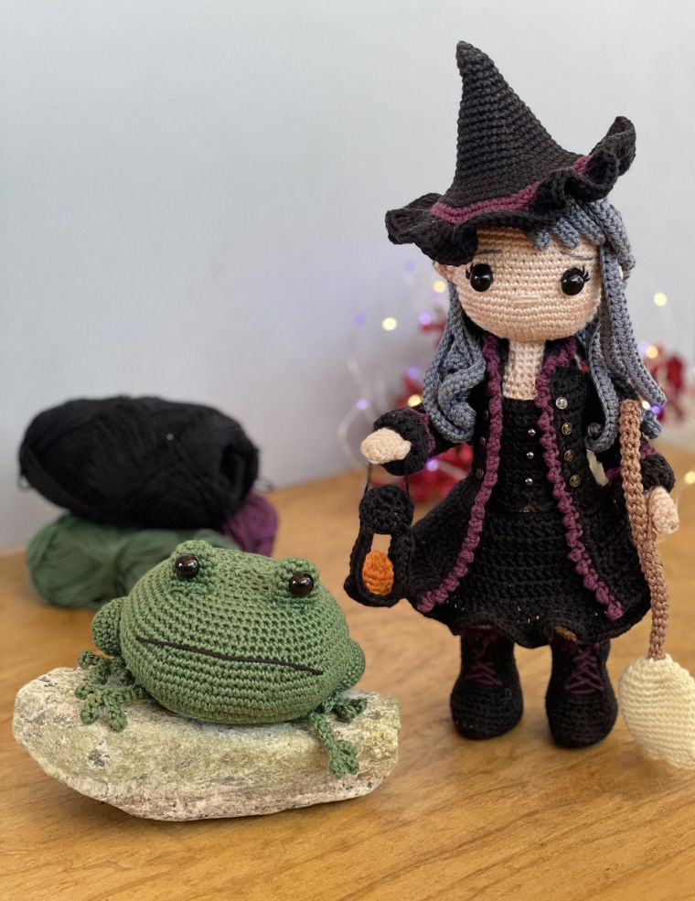 Niona the Witch crochet doll holding a lantern beside Bufo the toad